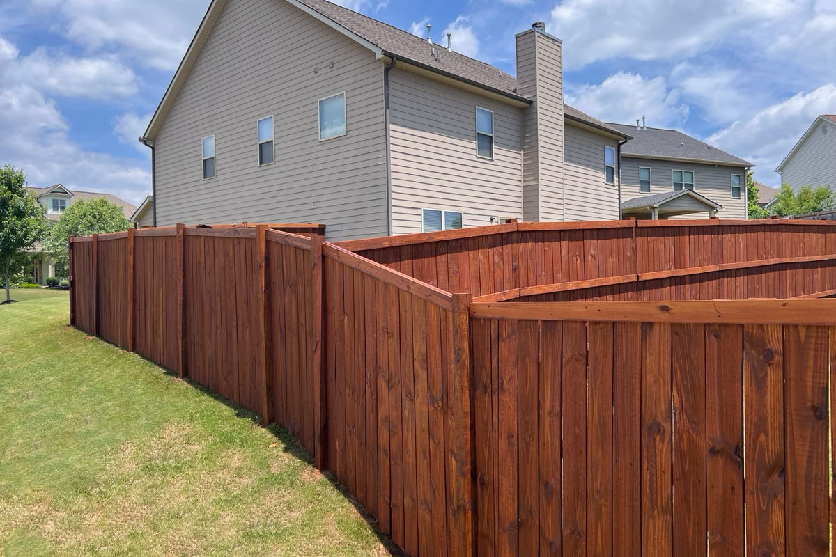 Oil-stained fence in Greer, SC